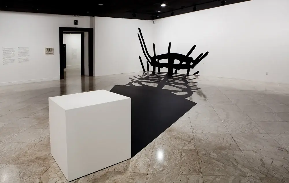 Masterpieces (In Absentia): Meret Oppenheim, 2012 — Adhesive vinyl and wooden pedestal